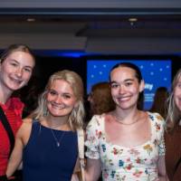 Four grads smile at Toast